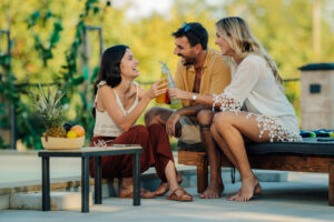 Photo of Friends toasting poolside on a patio