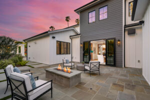 photo of Outdoor seating area with a fire pit and chairs during sunset.