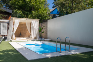 Photo of a Custom poolside cabana with curtains and lounge seating in Lakewood Ranch home