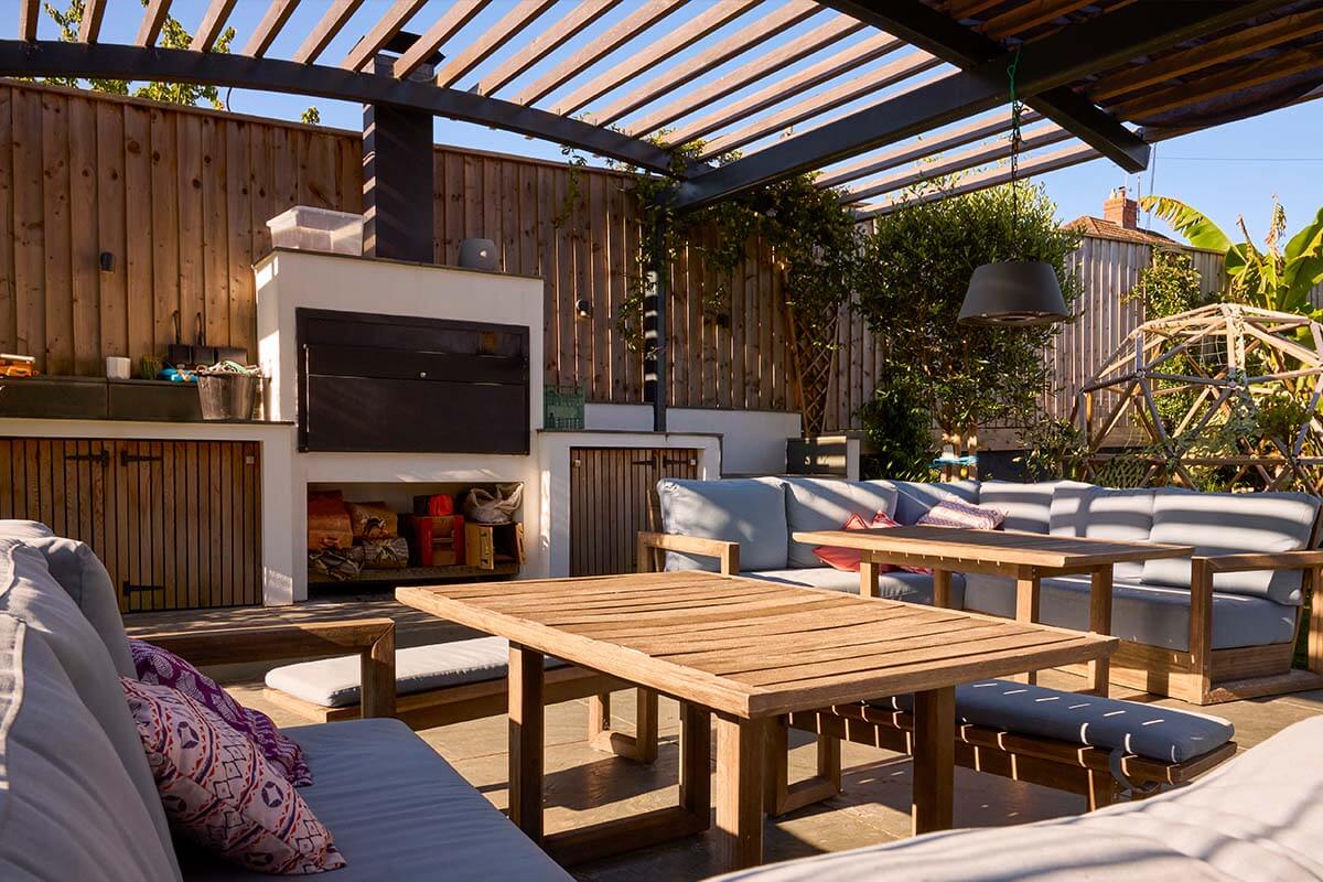 Louvered Pergola Over Outdoor Kitchen by contractors in Sarasota